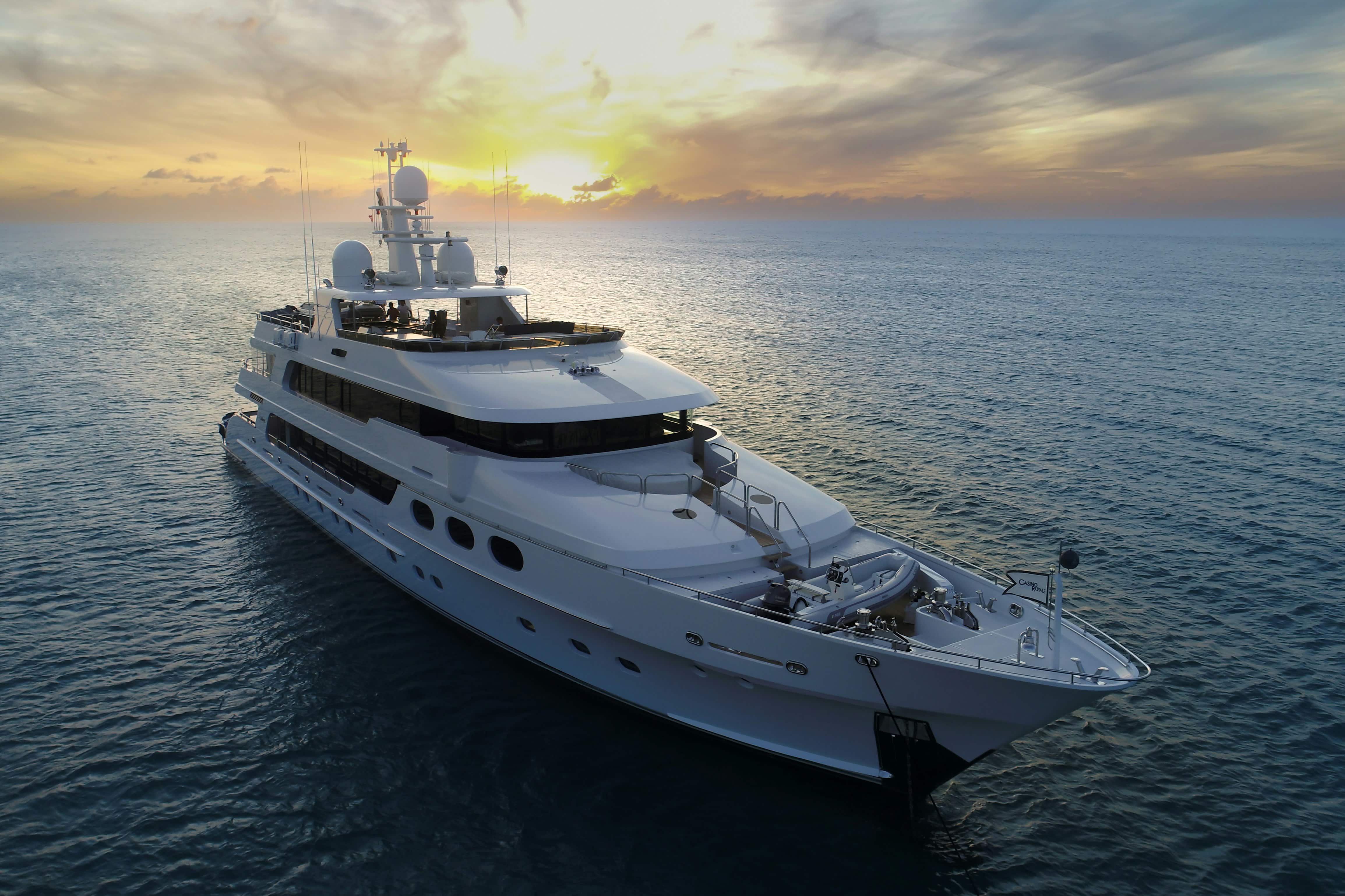 Luxury superyacht sailing through turquoise waters at sunset, embodying oceans of grandeur